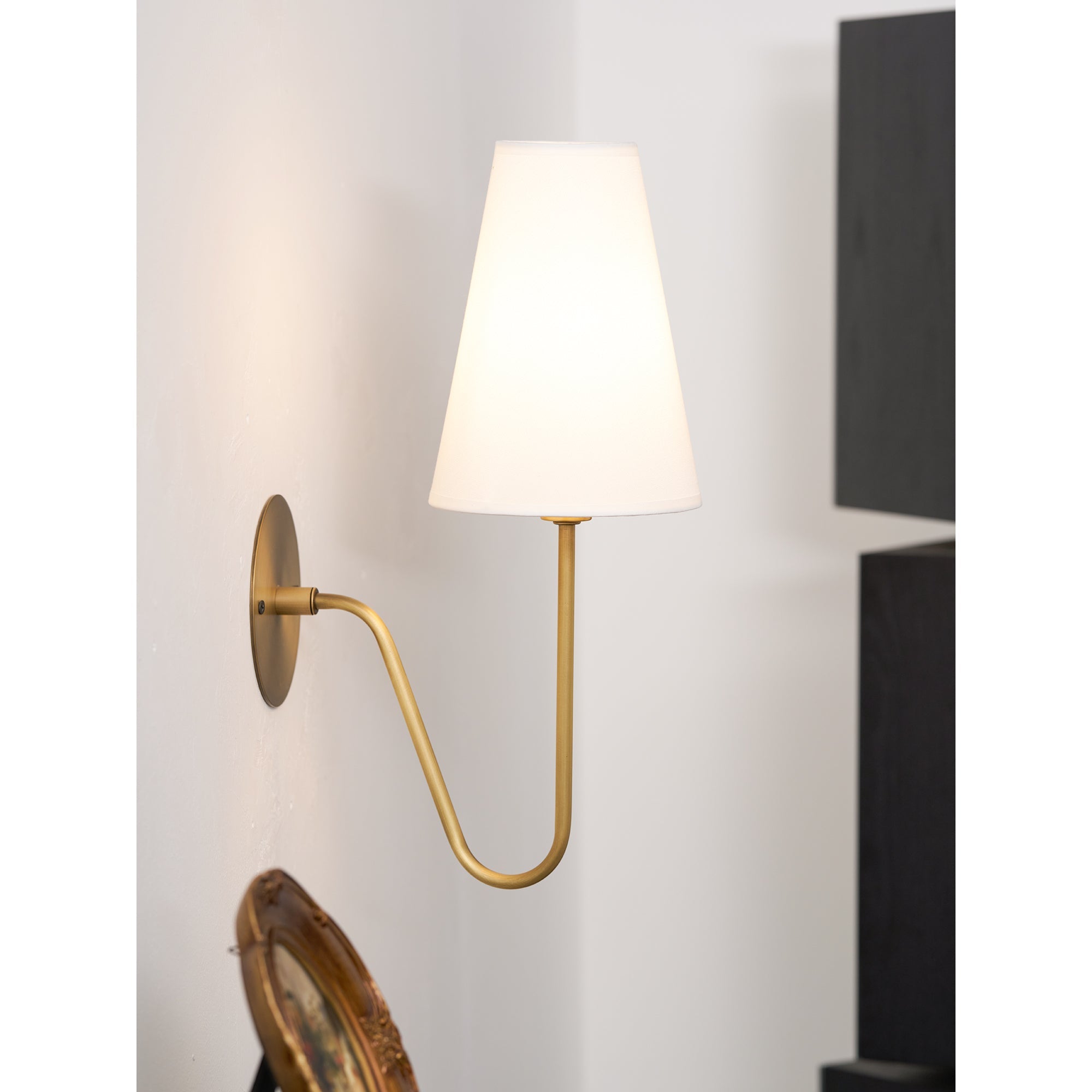 Cove Antiqued Brass Curved Sconce