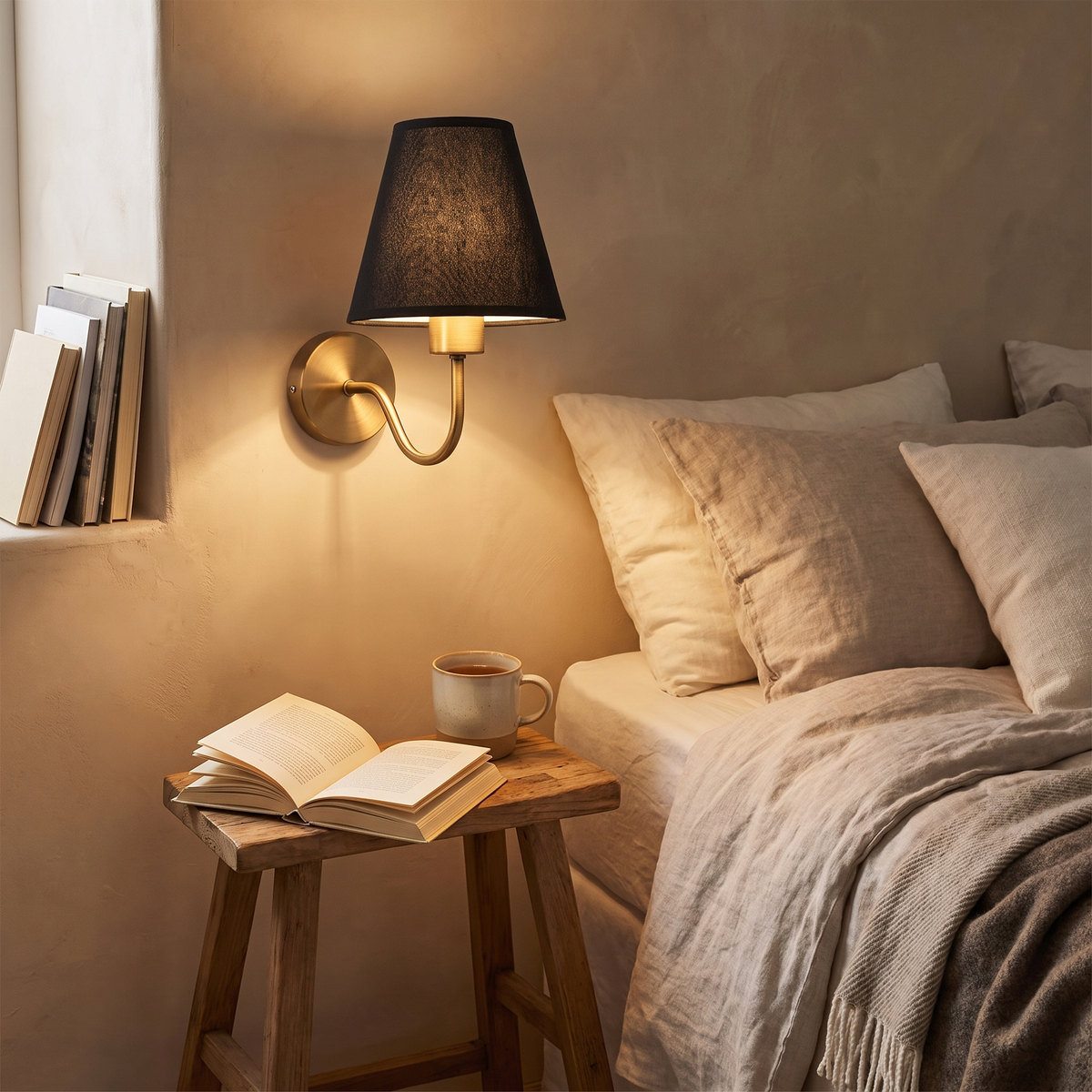 Antique Brass Tapered Shade Wall Sconce beside bed