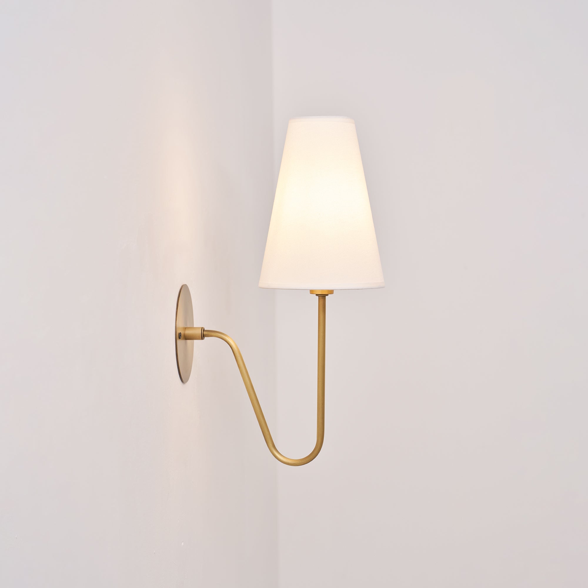 Cove Antiqued Brass Curved Sconce