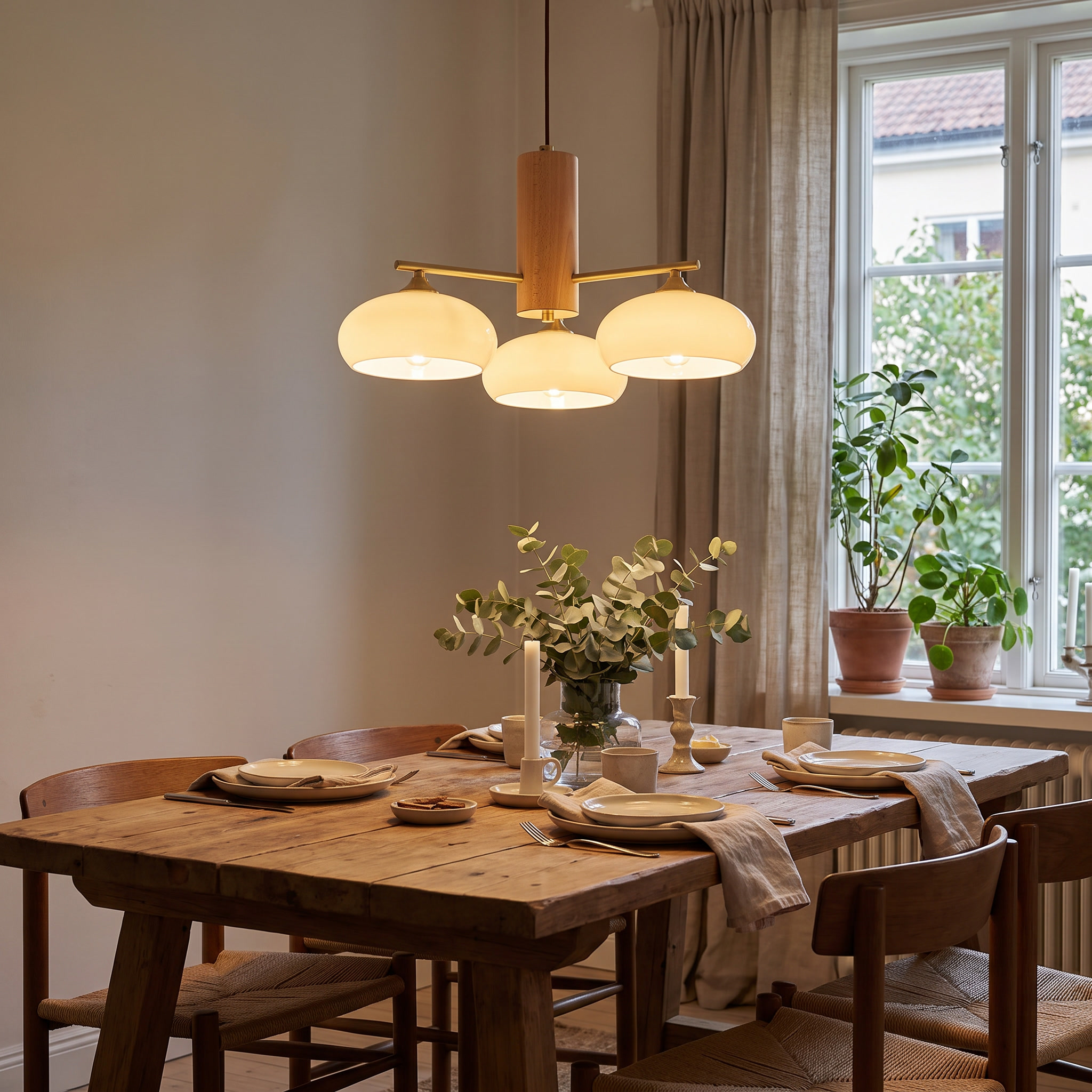Nova Elliptical Persimmon Chandelier in use above a dining table